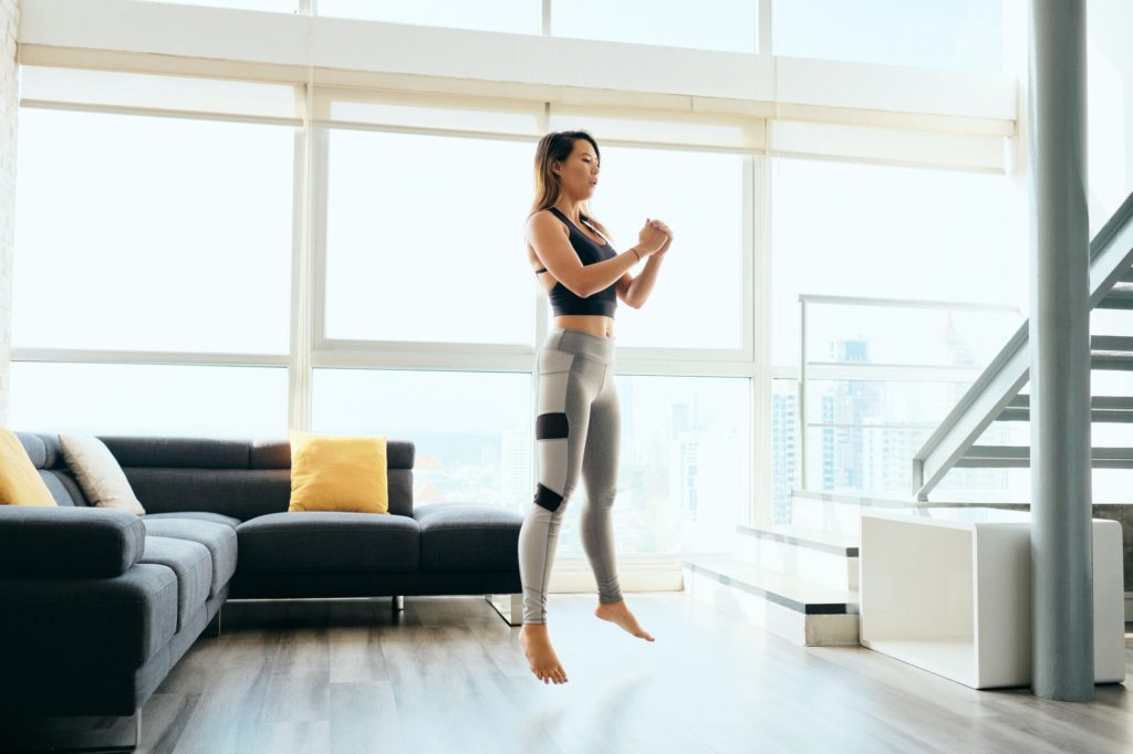 Adult Woman Training Legs Doing Squat and Jumping