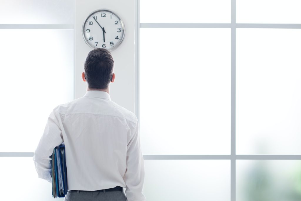 Businessman staring at the clock