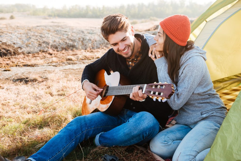 Couple with guitar outdoors