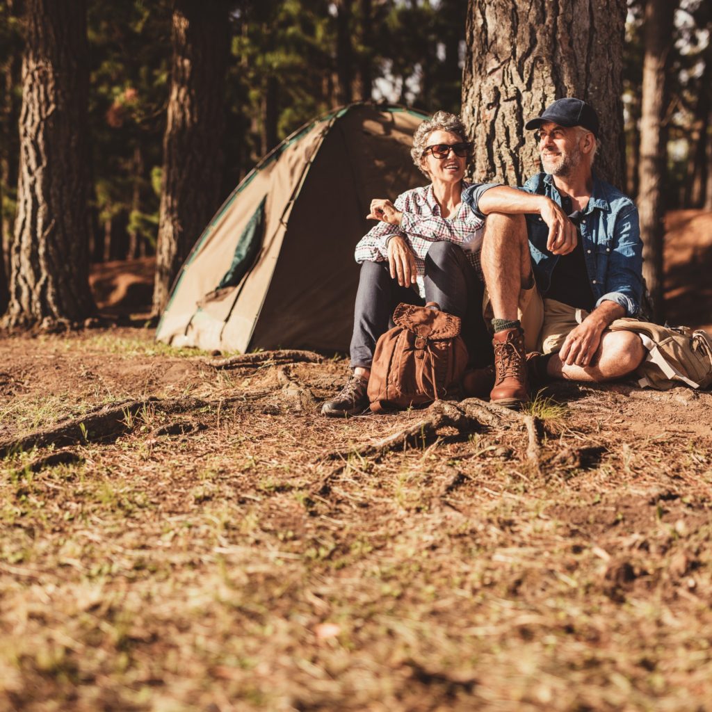 Mature couple relaxing at their campsite